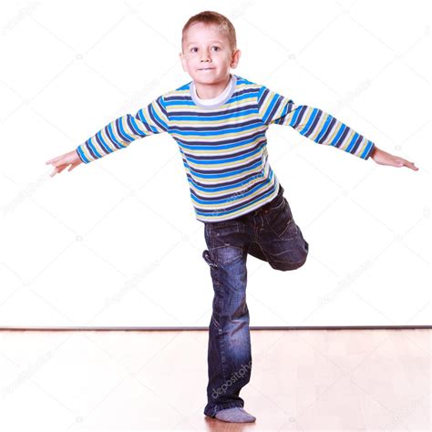 Little Boy Have Fun Alone At Home Stand On One Leg Stock Photo By
