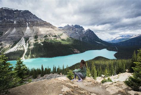 Woman Sitting On Rock Overlooking Peyto Lake In The Rocky Mountains