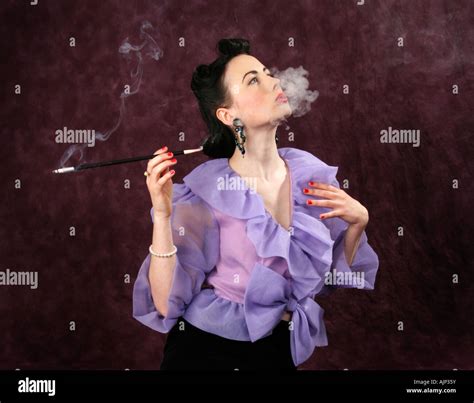 A Pin Up Girl In A Purple Blouse Holding A Cigarette Holder And Smoking