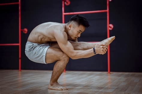 Flexible Young Asian Man Doing Balancing Asana During Hatha Yoga