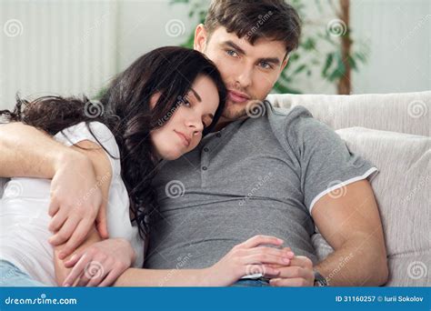 Young Couple Are Sitting Down On A Couch Stock Image Image Of Couch