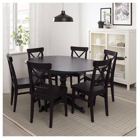 You can add folded chairs which are easily stored when not used. IKEA INGATORP Black Extendable table | Black round dining ...