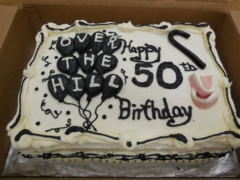 over the hill 50th birthday cake with false teeth cane and balloons black and white cake