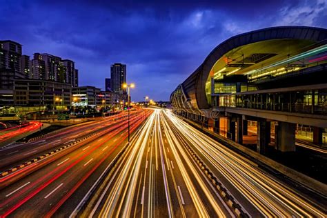Light Trail Of Busy Traffic With Lrt Station Railway Office Buildings