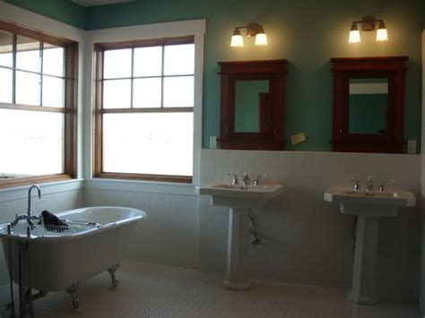 A Bath Room With Two Sinks And A Bath Tub