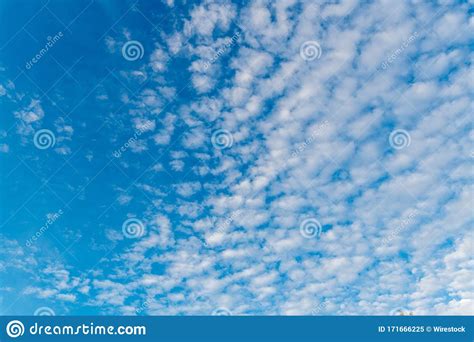 Low Angle Shot Of A Beautiful Cumulus Cloud In A Clear Blue Sky Stock