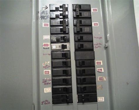 The Electrical Panel Is Covered In Stickers And Magnets On Its Sides