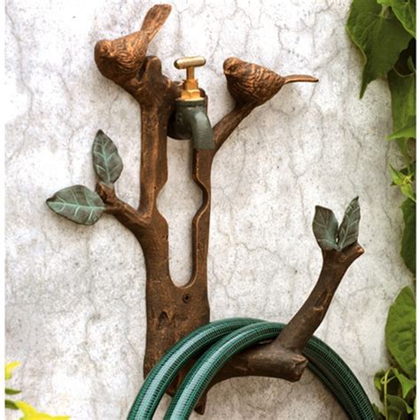 Garden hose neatly and conveniently out of the way. Home Sweet Home: Decorative Garden Hose Holder!