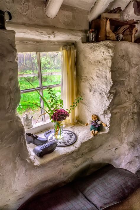 Garden View From A Victorian Cottage Window With Old Boots