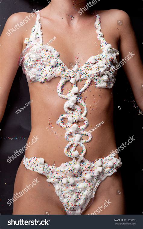 Torso Of Woman In Whipped Cream Swimsuit Stock Photo 111253862