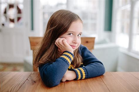 Cute Young Girl Smiling At Table By Stocksy Contributor Jakob