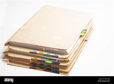 A Stack Of Patient Medical Records In Folders With Color Coded And