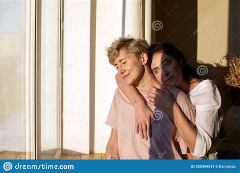 Lesbian Couple Enjoying Sunlight Near Window Stock Image Image Of Amorous Morning 205394211