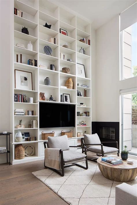 Dramatic Tall White Bookcase With A Built In Tv In This Modern Living