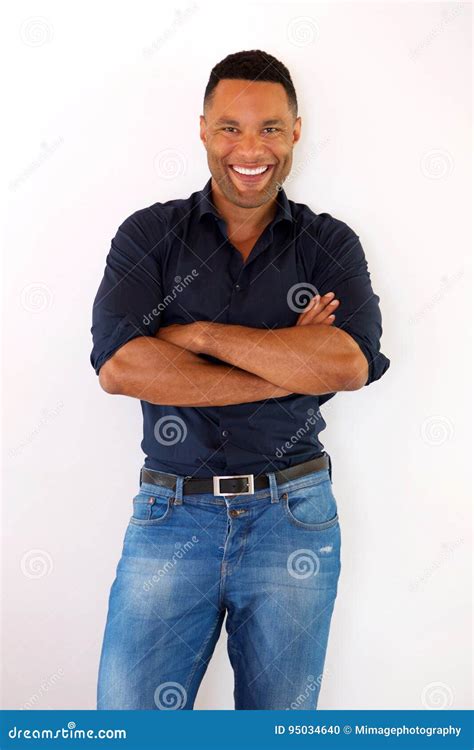 Confident Young Black Guy Standing With Arms Crossed And Smiling Stock