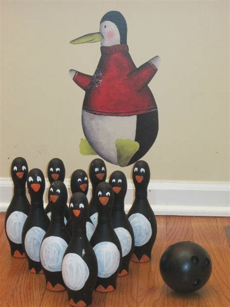 A Group Of Black And White Penguins Sitting On Top Of A Wooden Floor
