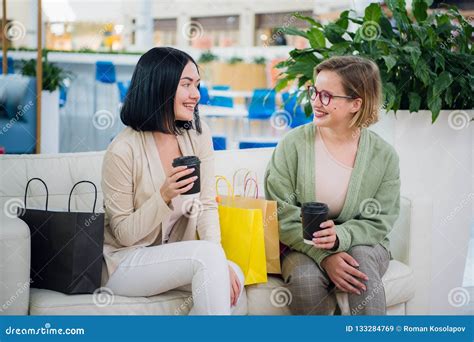 Two Young Woman Chatting In A Coffee Shop Stock Image Image Of