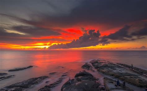 Red Sky Dark Clouds Reflection Sunset At The Coast Of