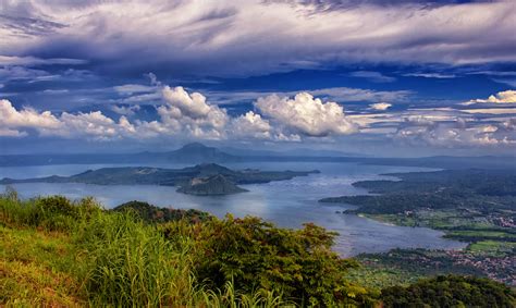 Green Trees Surrounded By Body Of Water Under Cloudy Sky Taal Lake