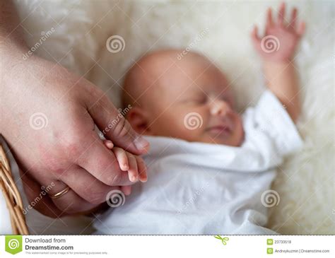 Dad Keeping Carefully Sleeping Newborn Baby Hand Stock