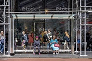 People At A Bus Stop Under A Scaffolding Stock Photo - Download Image ...