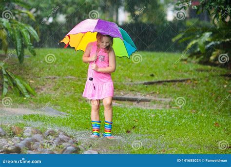 Kid With Umbrella Playing In Summer Rain Stock Photo Image Of Rain