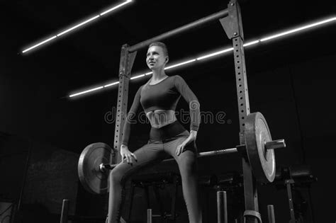 Leggy Girl Posing In The Gym She Leaned On The Barbell The Concept Of