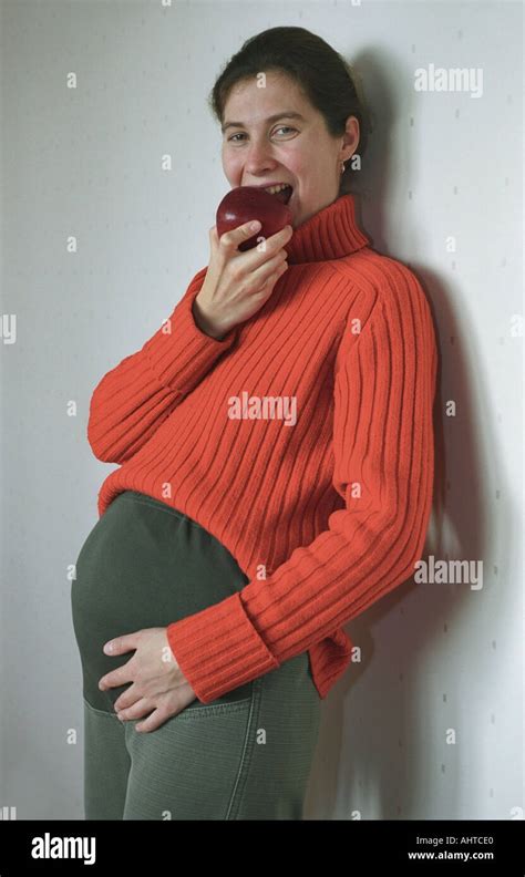Pregnant Woman Eating An Apple Russia Stock Photo Alamy