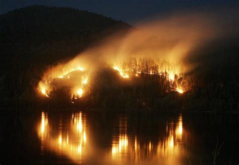 a forest fire blazes at the bank photograph by ilya naymushin fine art america