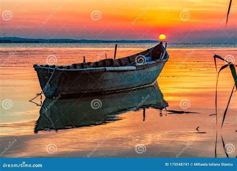 Beautiful Sunrise With A Boat Reflected On The Lake Stock Image Image