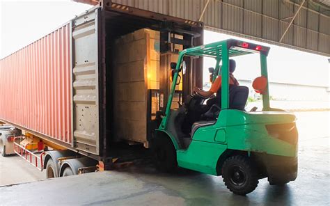 Forklift Driver Loading Goods Pallet Into The Truck Container Freight