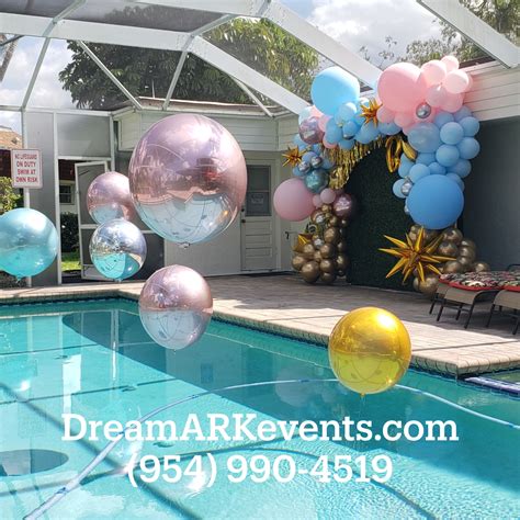 Floating Balloon Sin Swimming Pool And Greenery Backdrop With Organic Balloon Garland Is Perfect