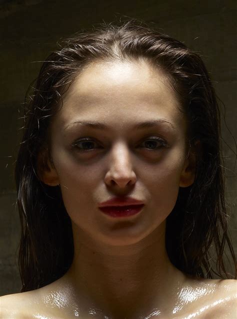 A Woman With Wet Skin And Red Lips