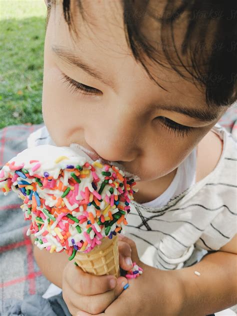 Little Kid Eating Ice Cream Cone By Stocksy Contributor Lauren Lee