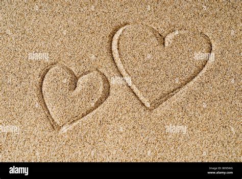 Two Hearts Drawn Into Beach Sand Stock Photo Alamy