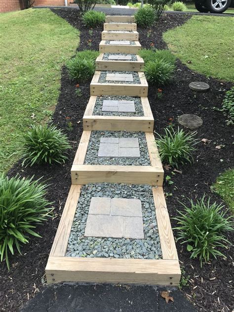 Rock and mulch flower beds. Stairway, lawn steps, timber steps, black mulch, flower ...
