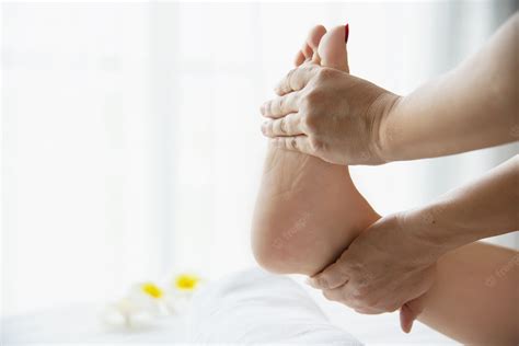 Free Photo Woman Receiving Foot Massage Service From Masseuse Close
