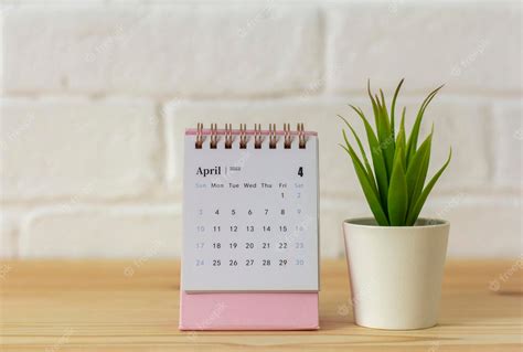 Premium Photo Desktop Calendar For April 2022 For Planning On The Table