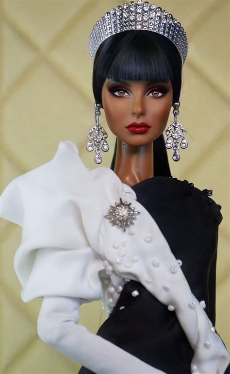 a barbie doll wearing a black and white dress with pearls on it s head