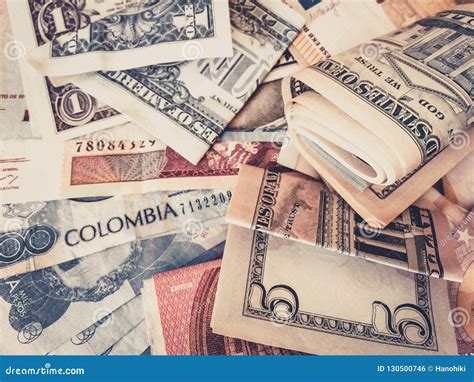 Cash Money US Dollars and Colombian Pesos - Stock Photo - Image of