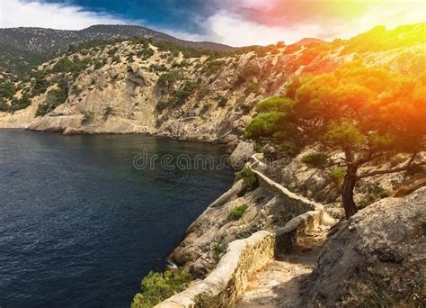 View Of A Secluded Sea Bay In Summer Surrounded By Mountain Cliffs With