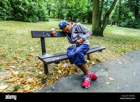 Senior Old Man On A Bench In A Park Loneliness A Homeless Man In A City Park Stock Photo Alamy