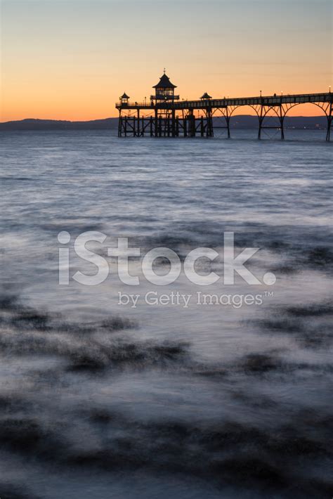Long Exposure Landscape Image Of Pier At Sunset In Summer Stock Photo
