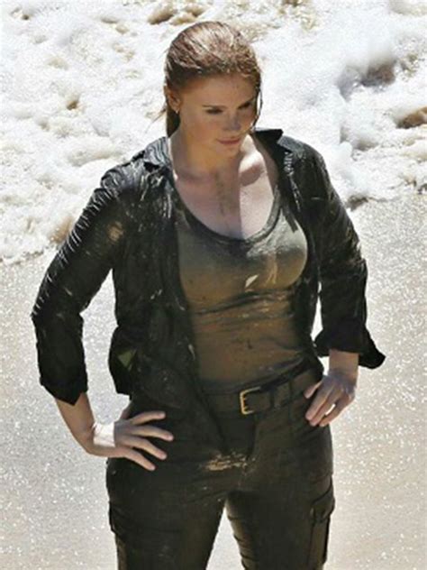 A Woman Standing In The Water With Her Hands On Her Hips And Wearing Black Clothes