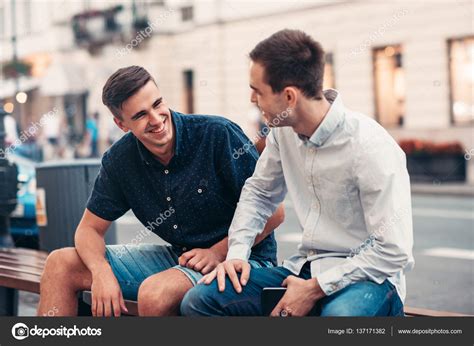 Friends Talking Together On Bench — Stock Photo © Mavoimages 137171382