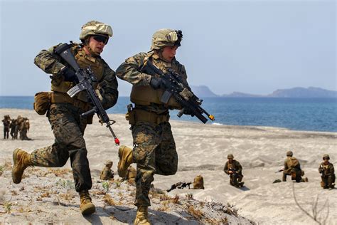 Us Marines Quickly Return To Their Amphibious Assault Vehicle To Grab