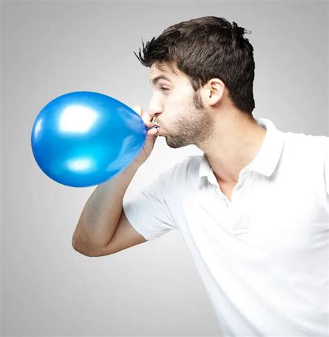 Man Blowing Balloon — Stock Photo © Coolfonk 10178408