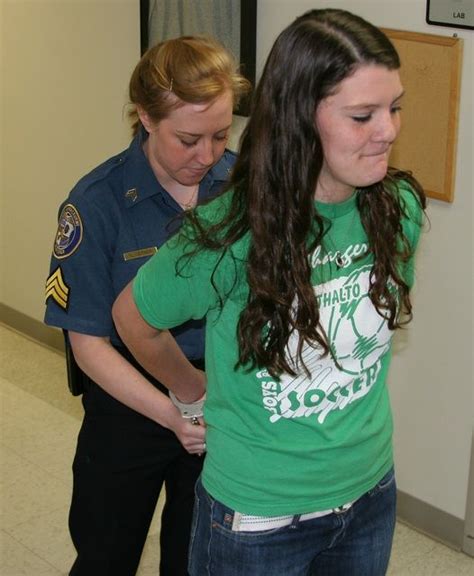 Young Woman Gets Her Hands Cuffed Behind Back At Police Open Day