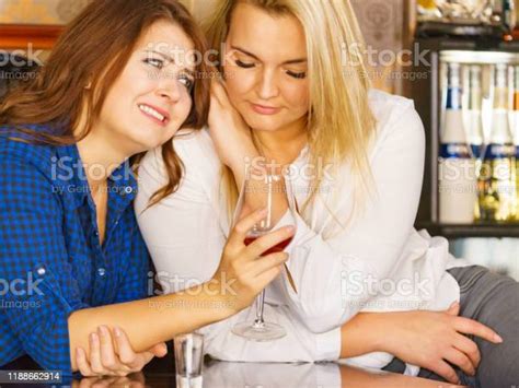 Sad Woman Crying And Being Consoled By Friend Stock Photo Download