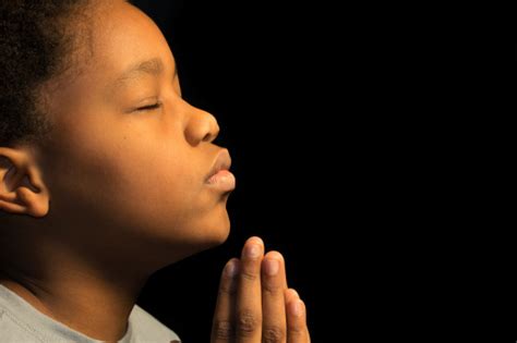 An Africanamerican Boy Praying To His God Stock Photo Download Image